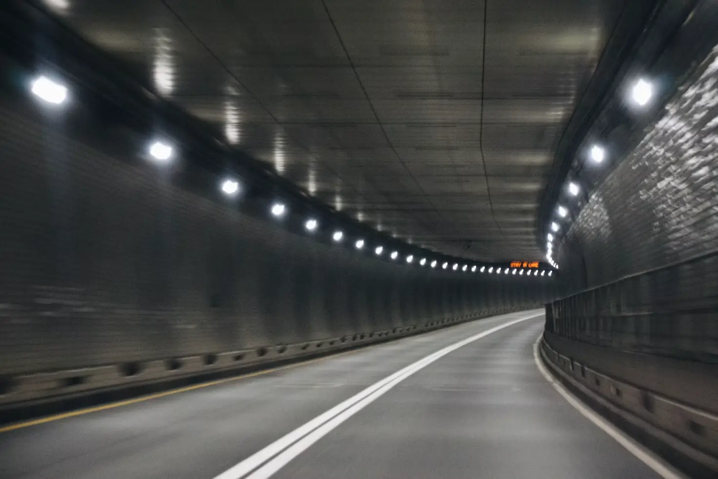 Crossed-type ultrasonic wind speed detector and transmissometer installed inside a highway tunnel for ventilation and smoke monitoring.