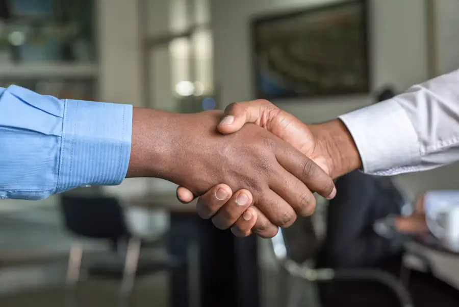 Business partners shaking hands, representing Virtue's commitment to long-term OEM cooperation and reliable global supply of meteorological sensors.